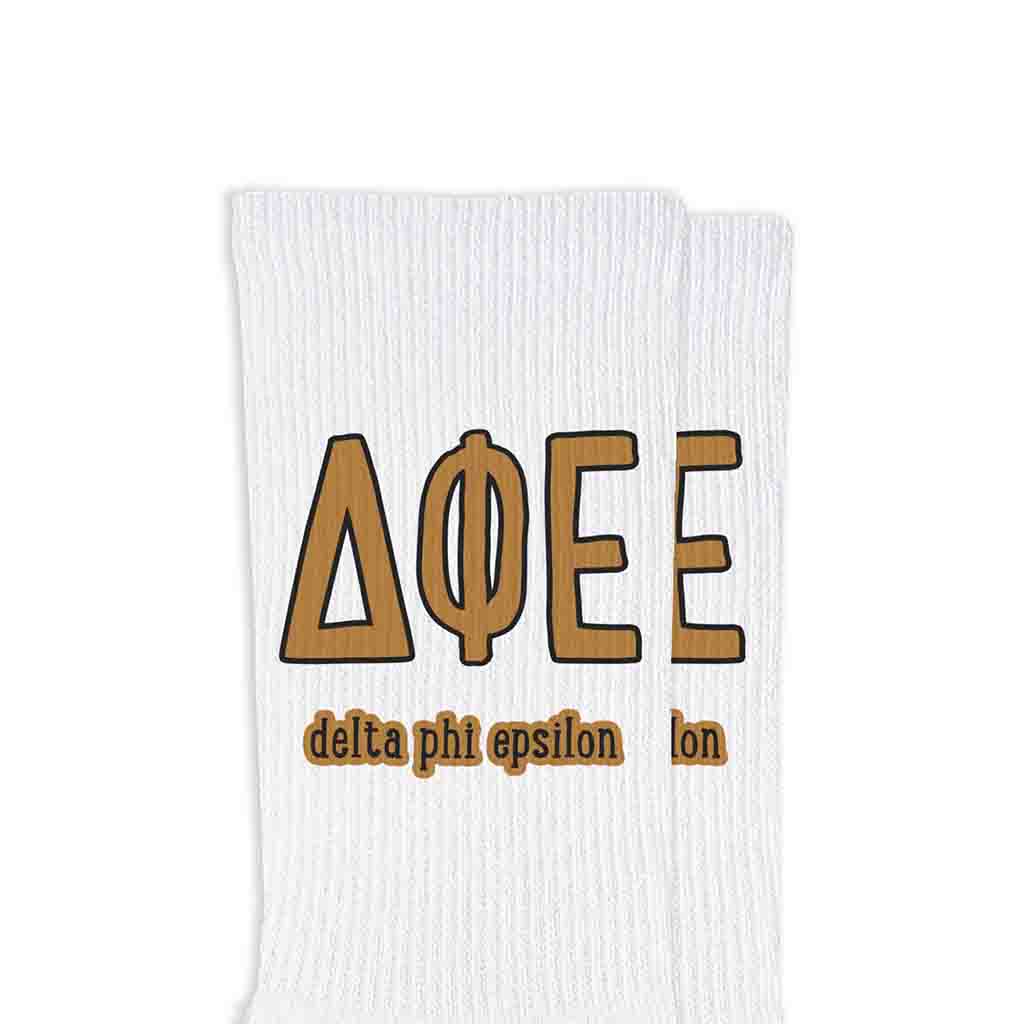 Delta Phi Epsilon sorority letters and name digitally printed on white crew socks.