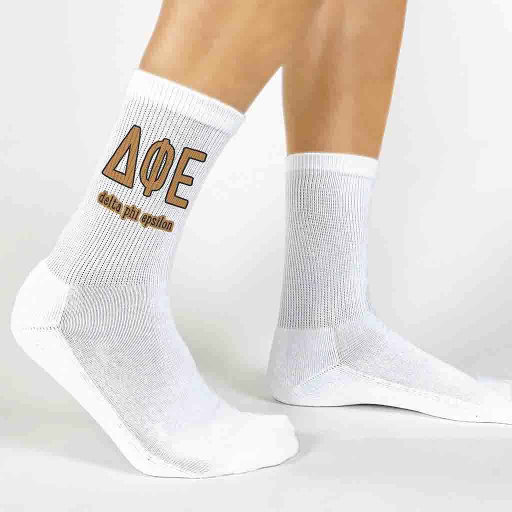 Delta Phi Epsilon sorority letters and name digitally printed on white crew socks.