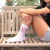 Delta Zeta sorority letters and name digitally printed on white crew socks.