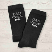 Personalized black crew socks for dad with the established date added to the design