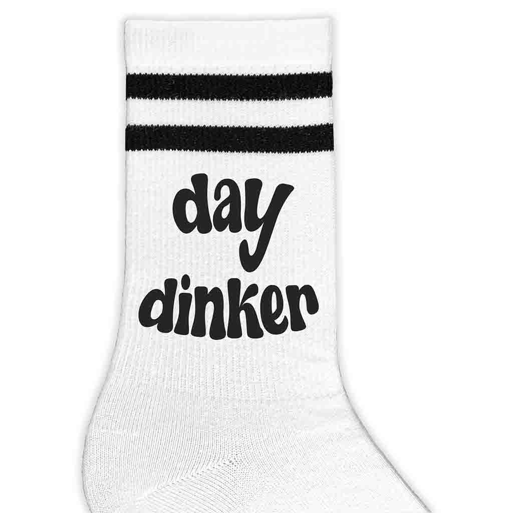 Super cute pickleball crew socks digitally printed with day dinker custom printed on the side of the white crew socks with black stripes.