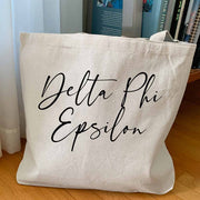 Delta Phi Epsilon sorority nickname custom printed on canvas tote bag is the perfect college tote bag.