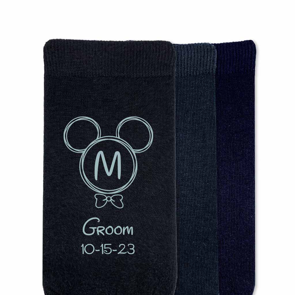 Disney and Mickey Mouse inspired monogrammed personalized wedding socks with your date, initial, and role printed in light blue ink.