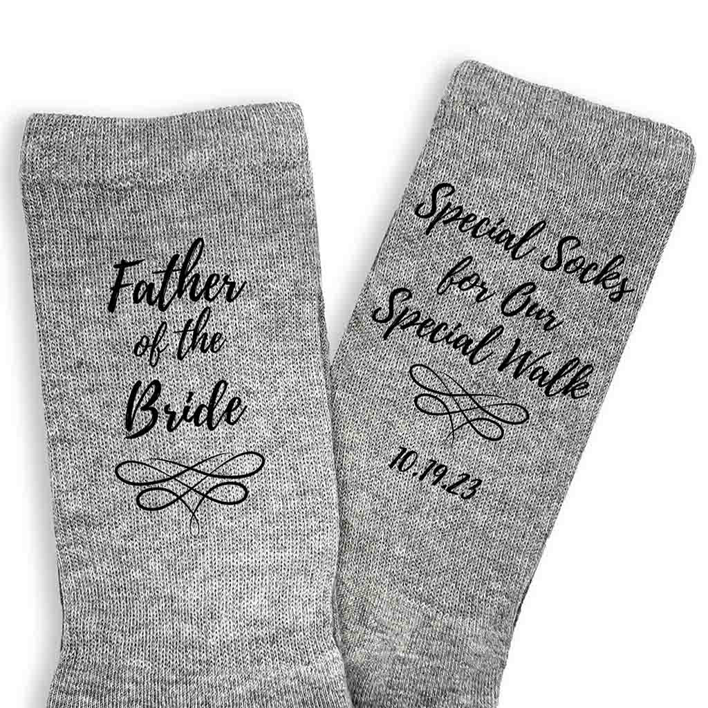 Special socks for a special walk custom printed with your wedding date and father of the bride on flat knit dress socks on heather gray crew socks.