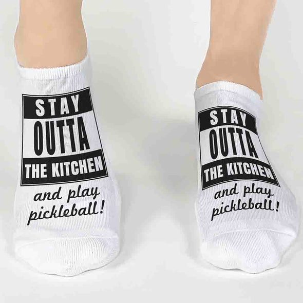 Super cute pickleball socks digitally printed with stay outta the kitchen and play pickleball on the top of the white no show socks.