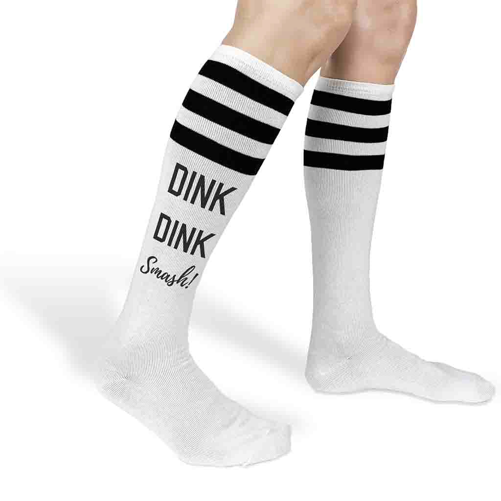 Dink dink smash pickleball design custom printed on the side of striped knee high socks.
