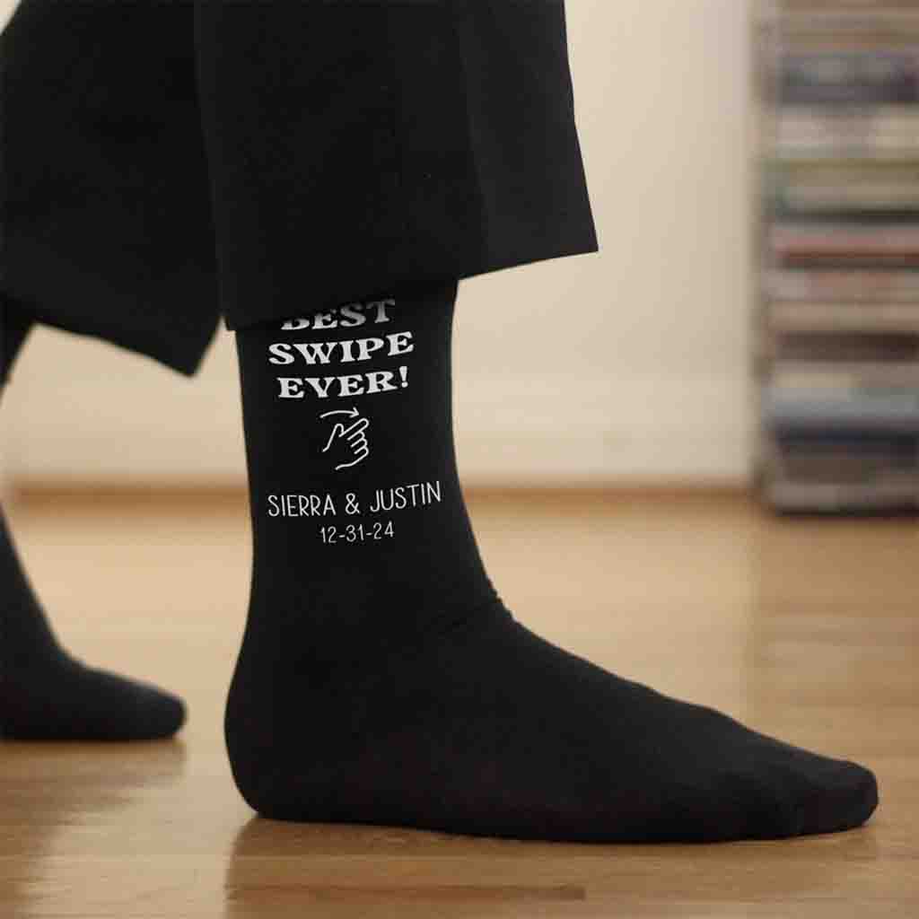 Fun pair of personalized groom socks make the perfect wedding accessory for the big day with the “swipe right” hand design is customized with the names of the couple along with their wedding date.