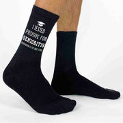 2023 Grad socks for the senior class of 2023 with I tested positive for seniorities graduation is the only cure digitally printed on the side of cotton crew socks.