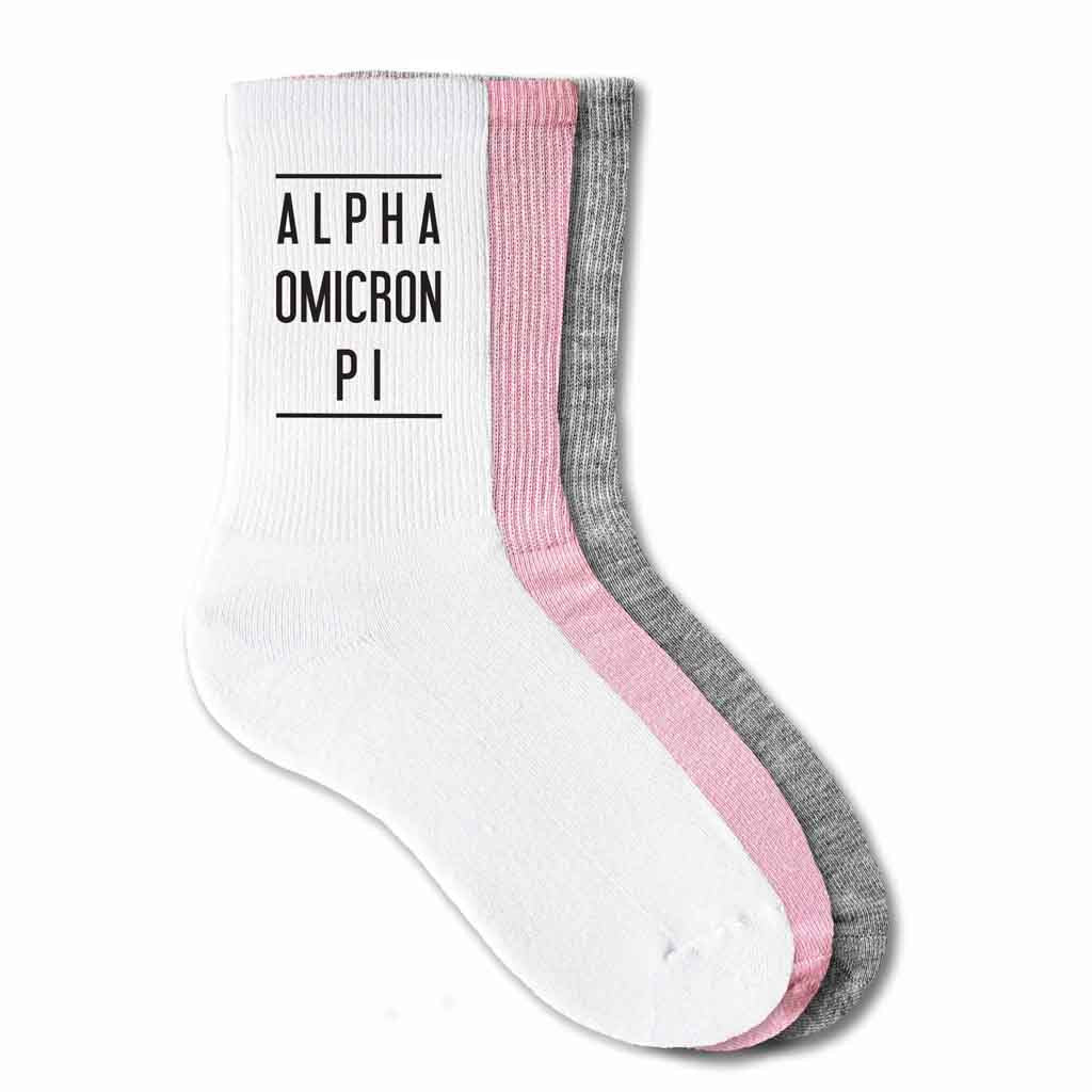 Alpha Omicron Pi sorority name custom printed on pink, white, or heather gray cotton crew socks.