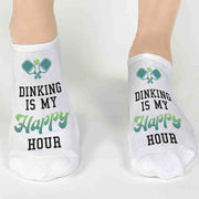 Super cute pickleball socks digitally printed with Dinking is my happy hour on the top of the white no show socks. Makes a great pickleball gift