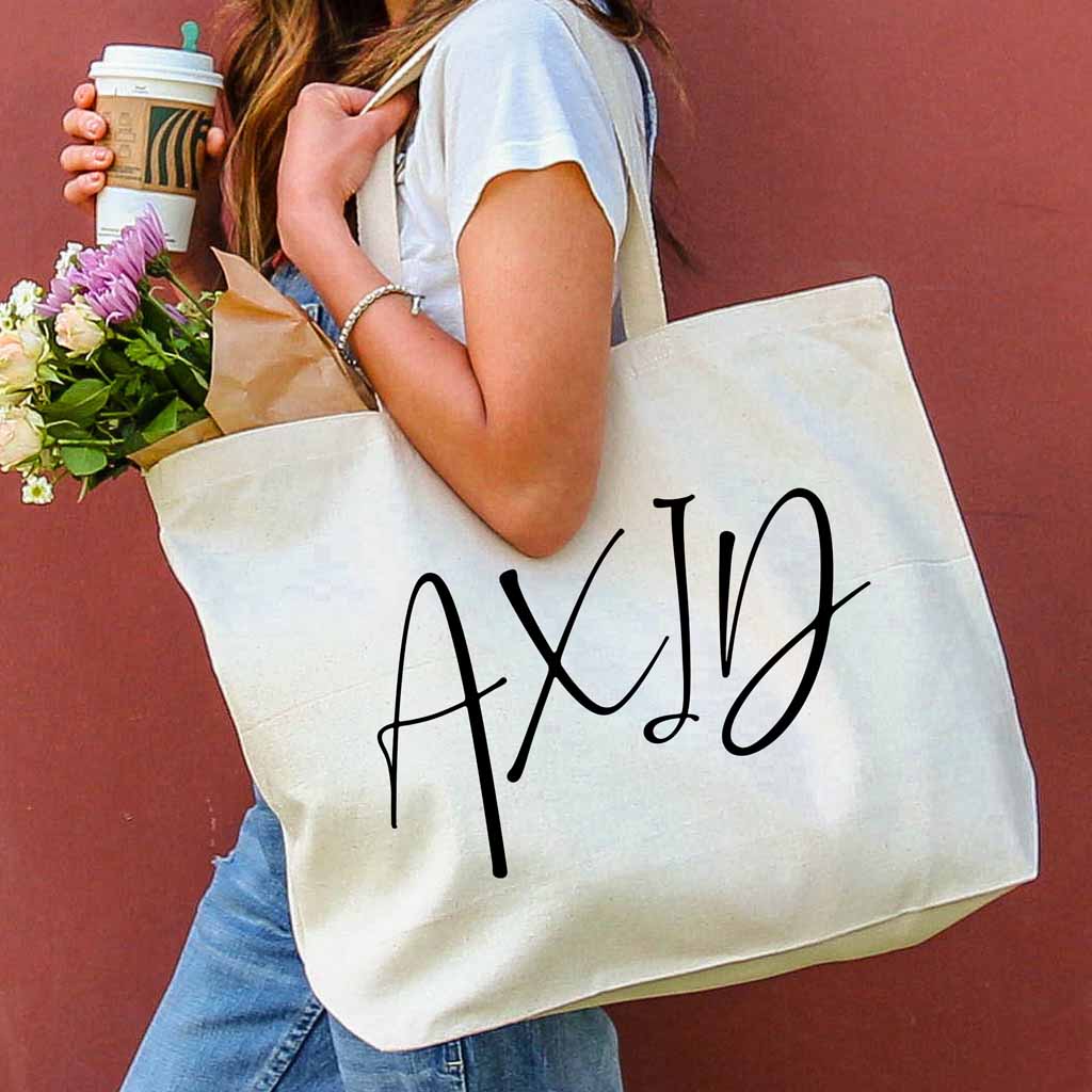 Alpha Xi Delta sorority nickname printed on a canvas tote bag in script writing is a great gift for your sorority sisters.