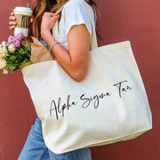Alpha Sigma Tau sorority nickname printed on a canvas tote bag in script writing is a great gift for your sorority sisters.