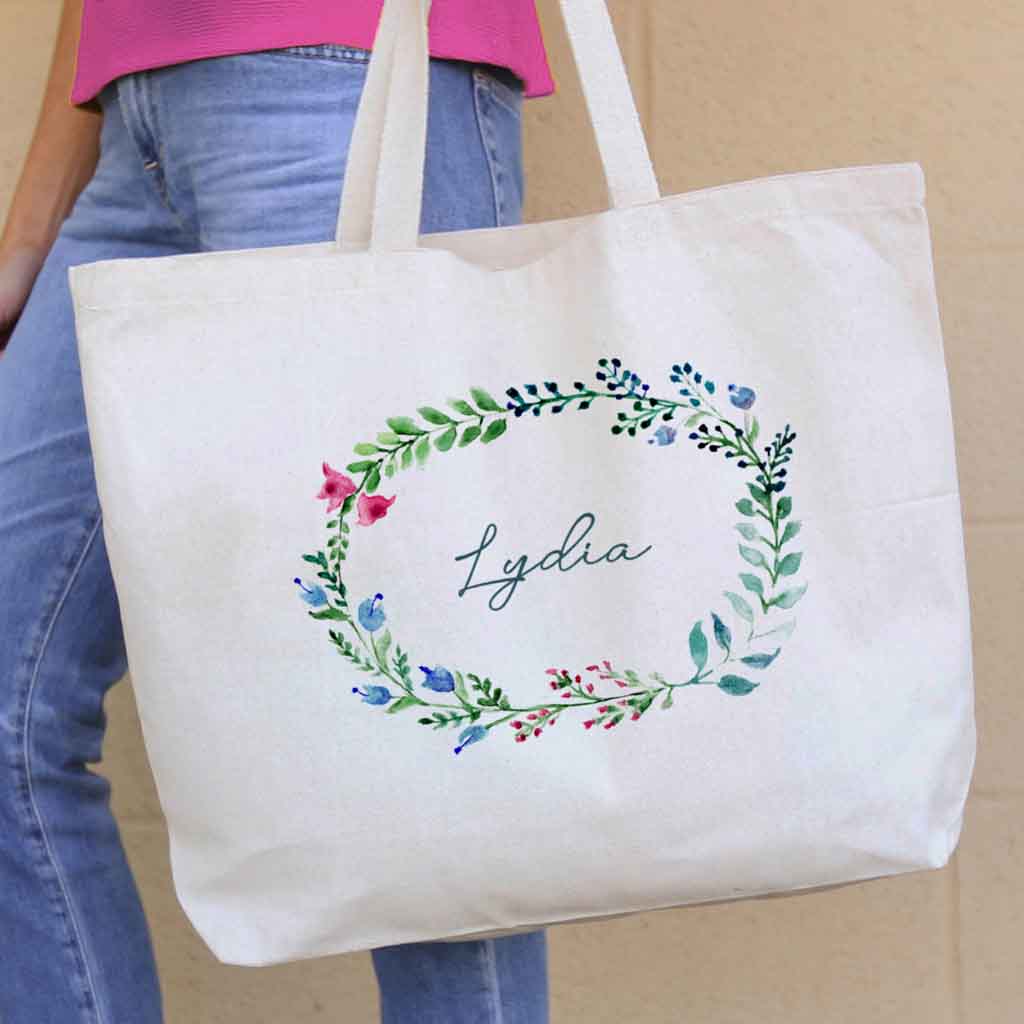 Large canvas tote bag for the wedding party personalized name in a farmhouse floral theme.