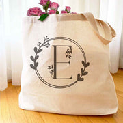 Large monogrammed bridesmaid tote bag personalized with a floral theme design.