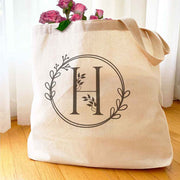 Large monogrammed bridesmaid tote bag personalized with a floral theme design.