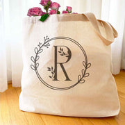 Large monogrammed bridesmaid tote bag personalized with a floral theme design.