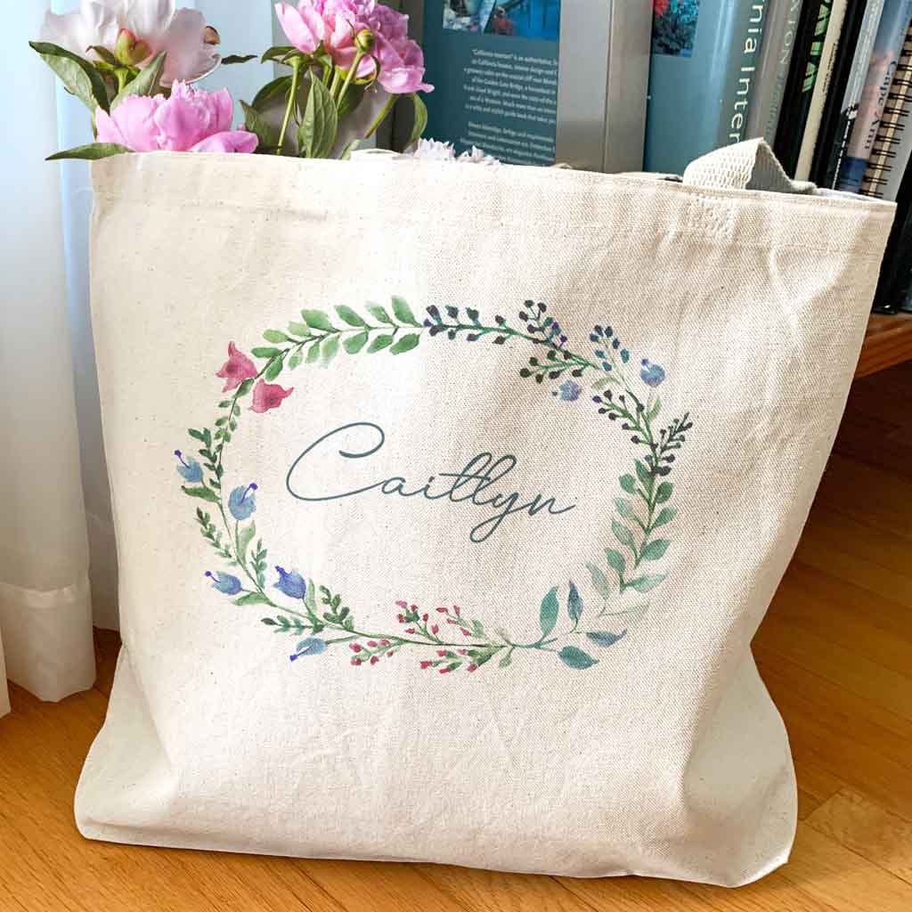 Large canvas tote bag for the wedding party personalized name in a farmhouse floral theme.