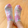 Soft and comfortable white cotton no show socks custom printed with self affirmation design abundance surrounds me.
