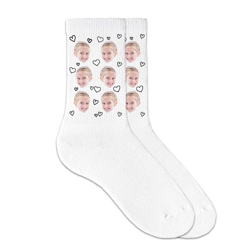 Cute socks custom printed and personalized using your own photo of faces with hearts all over design is digitally printed on white cotton crew socks to make a unique gift.