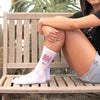 Phi Mu sorority letters and name digitally printed in sorority colors on white crew socks.