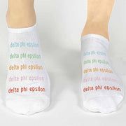 Delta Phi Epsilon sorority name printed in rainbow letters on comfy no show socks