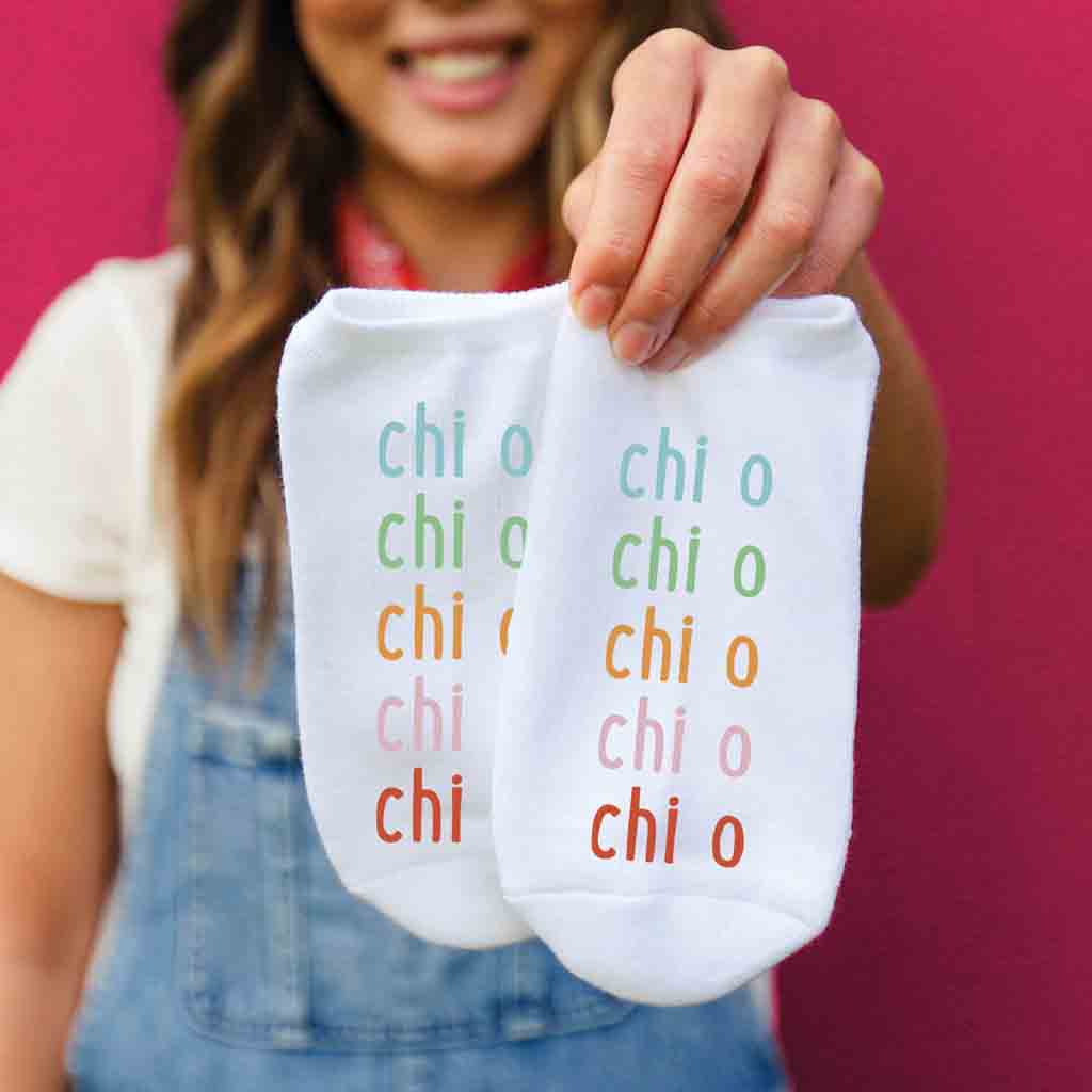 Chi Omega sorority name printed in rainbow letters on comfy cotton no show socks