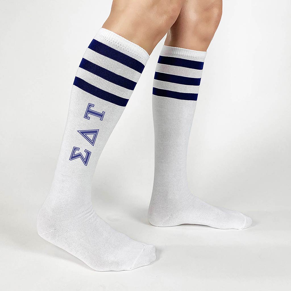 Sigma Delta Tau sorority letters custom printed on navy striped knee high socks