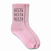 Delta Delta Delta sorority crew socks with the sorority name printed on the pink cotton socks