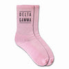 Delta Gamma sorority crew socks with the sorority name printed on the pink cotton socks