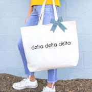 Delta Delta Delta sorority name custom printed on canvas tote bags with bow in sorority color