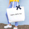 Sigma Delta Tau sorority name custom printed on canvas tote bag with bow