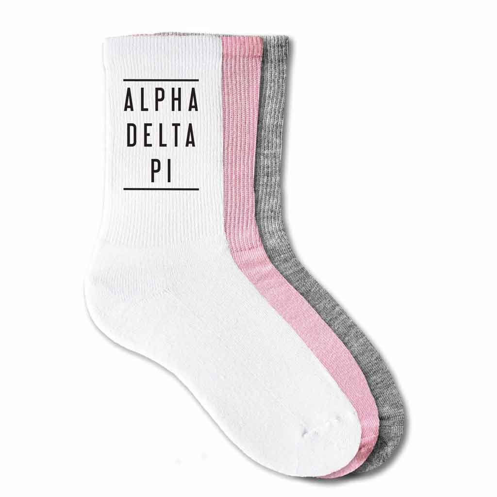 Alpha Delta Pi sorority name with lines design digitally printed in black ink on the sides of ribbed crew socks.