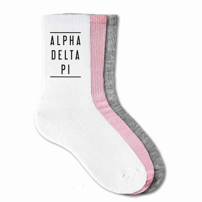 Alpha Delta Pi sorority name with lines design digitally printed in black ink on the sides of ribbed crew socks.