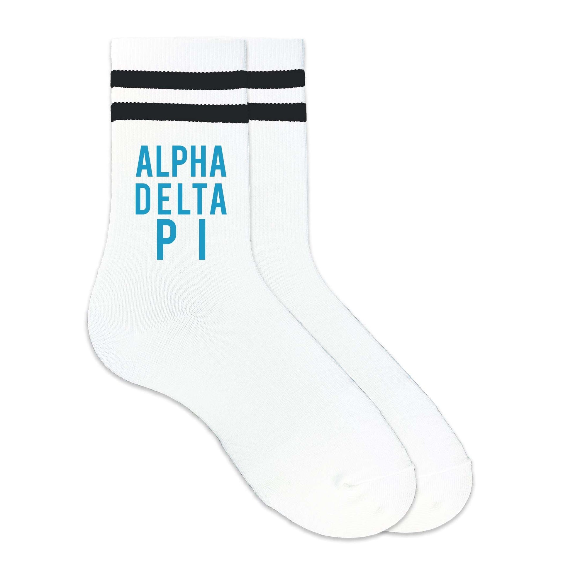 Alpha Delta Pi sorority name in sorority colors digitally printed on black striped crew socks.