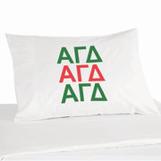 Alpha Gamma Delta sorority letters in repeat sorority colors design digitally printed on white cotton pillowcase.