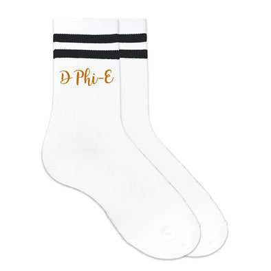 Delta Phi Epsilon nickname D Phi E digitally printed in sorority color ink on the side of black striped crew socks.