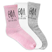 Theta Phi Alpha sorority name and letters digitally printed boho design on pink, white, or heather gray crew socks.