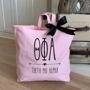Theta Phi Alpha sorority name custom printed on pink canvas tote bag with black bow