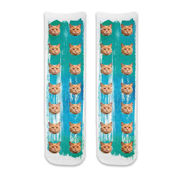Cat photo face socks custom printed using your cats face printed all over the crew socks with green blue paint brush background.