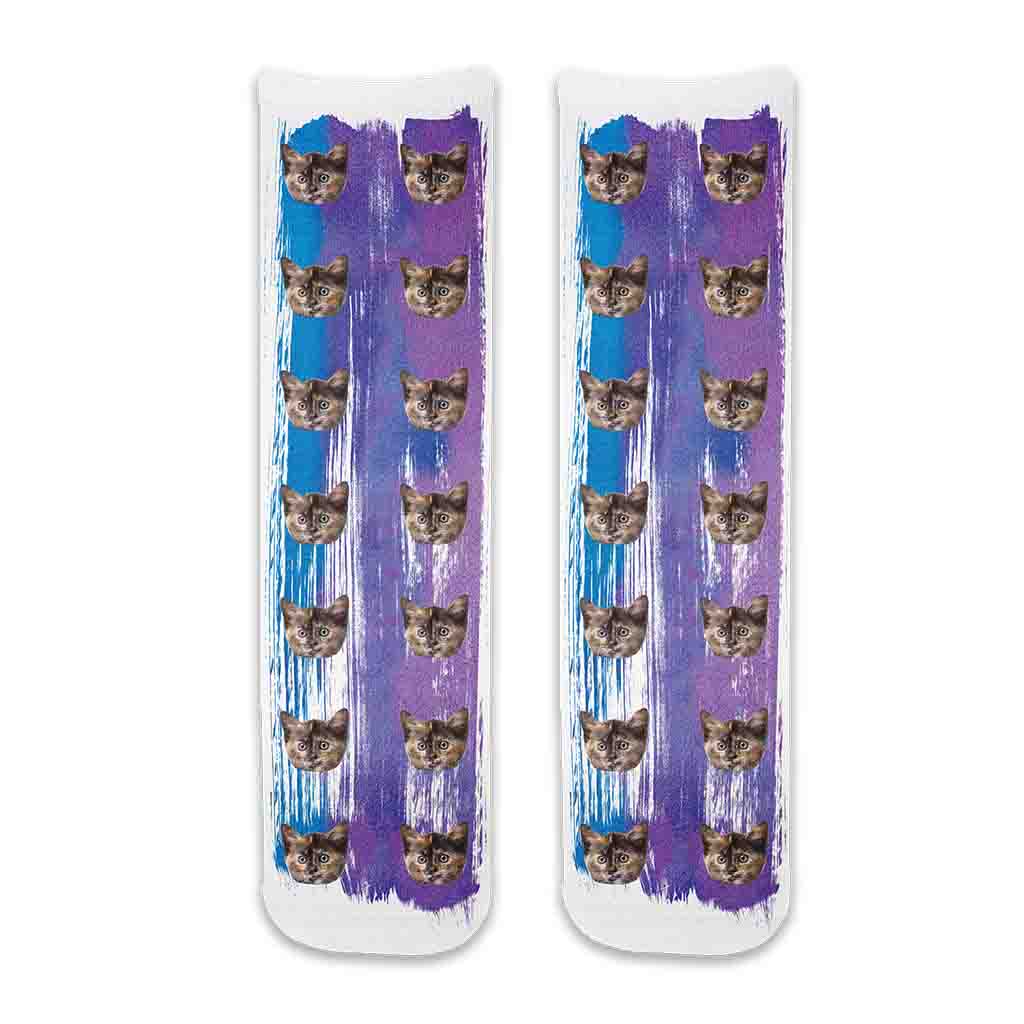 Fun photo socks personalized with your cats photos printed all over the cotton crew socks with purple blue paint brush background.