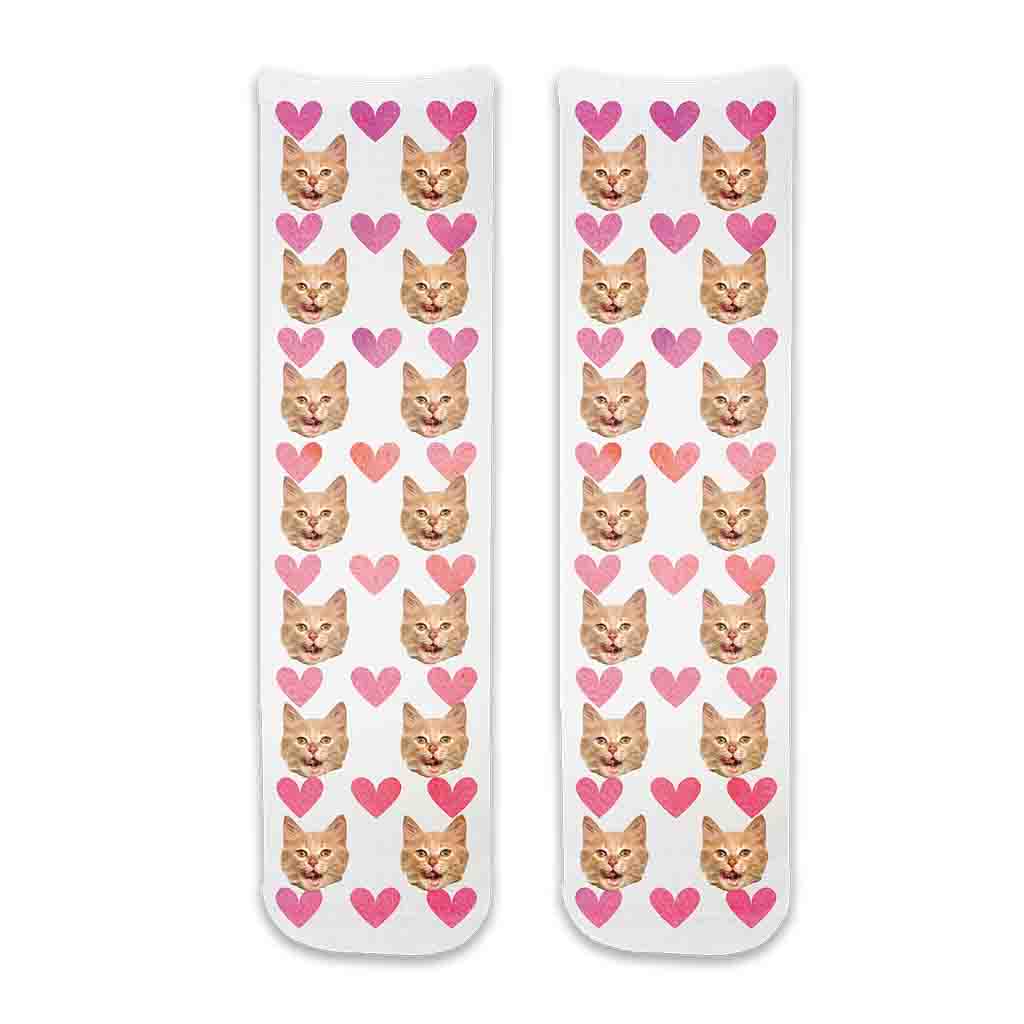 Photo face socks personalized using your cats photos printed all over the cotton crew socks with pink hearts background.