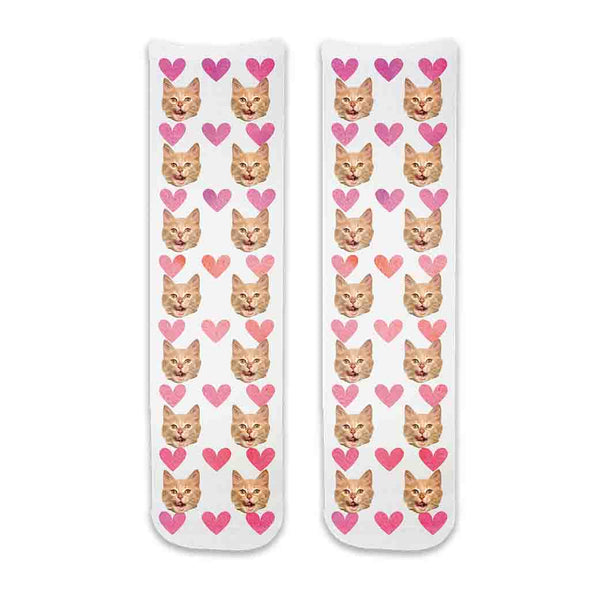 Photo face socks personalized using your cats photos printed all over the cotton crew socks with pink hearts background.