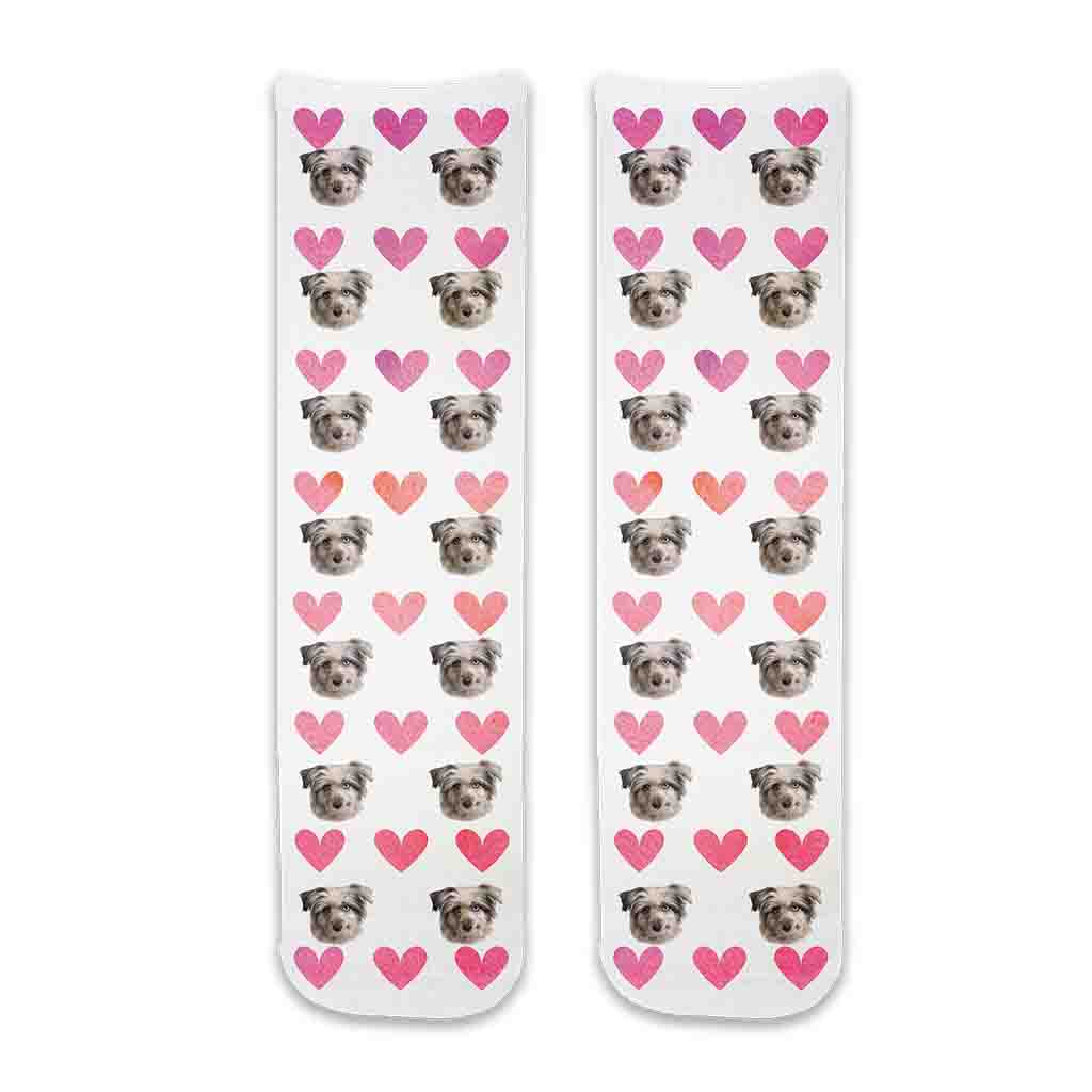 Custom pet photo socks personalized with your dogs face printed all over the cotton crew socks with pink hearts background makes a cute gift for your daughter.