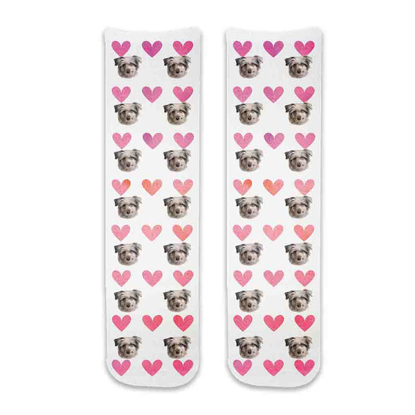 Custom pet photo socks personalized with your dogs face printed all over the cotton crew socks with pink hearts background makes a cute gift for your daughter.
