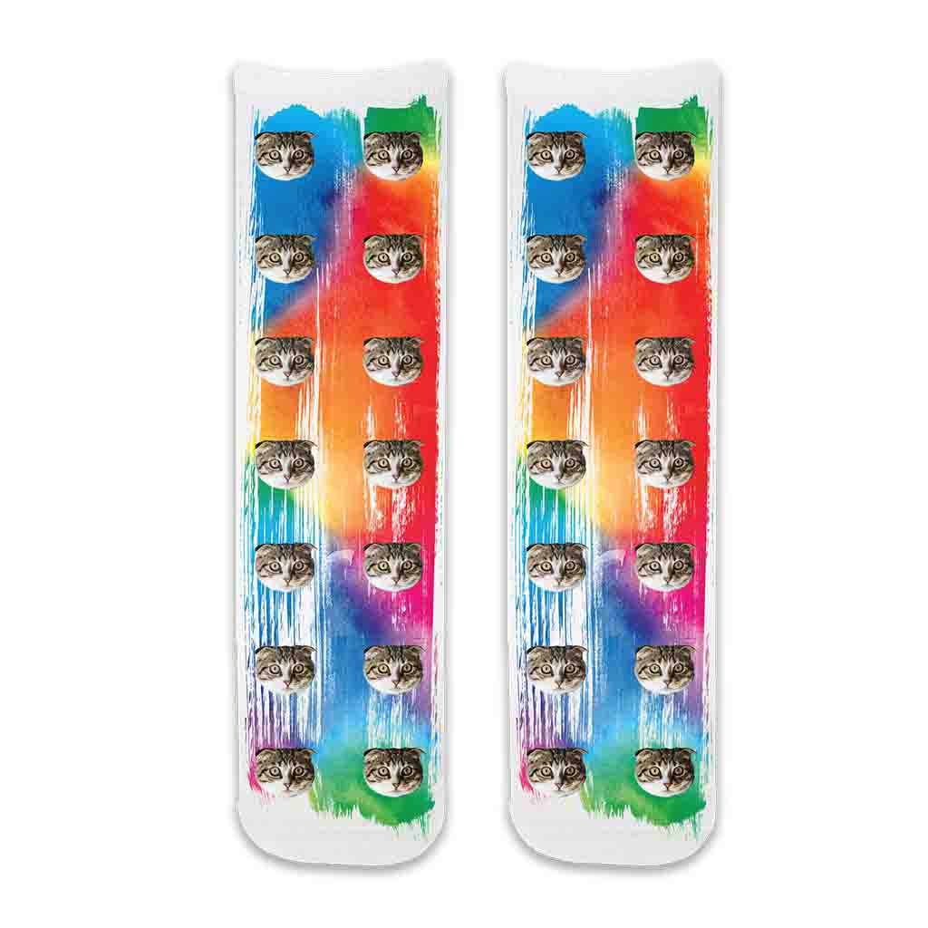 Custom cat photo socks personalized with your cats photos printed all over the cotton crew socks with rainbow paint brush background.