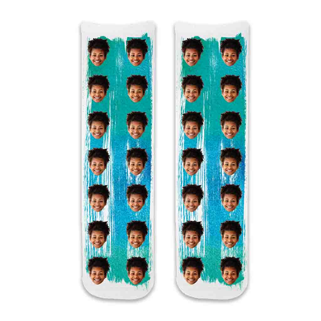 These fun photo face socks personalized using your photos are custom digitally printed on cotton crew socks with a green blue paint brush background.
