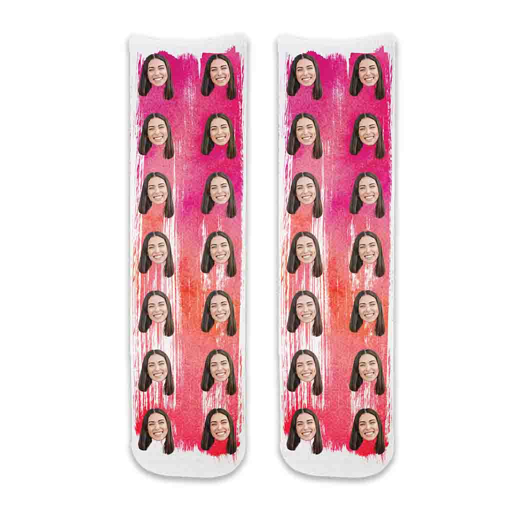 Personalized face socks with photos printed on cotton crew socks and pink paint brush background. And, wearing these super cute pink socks is a fun way to show support for breast cancer awareness.