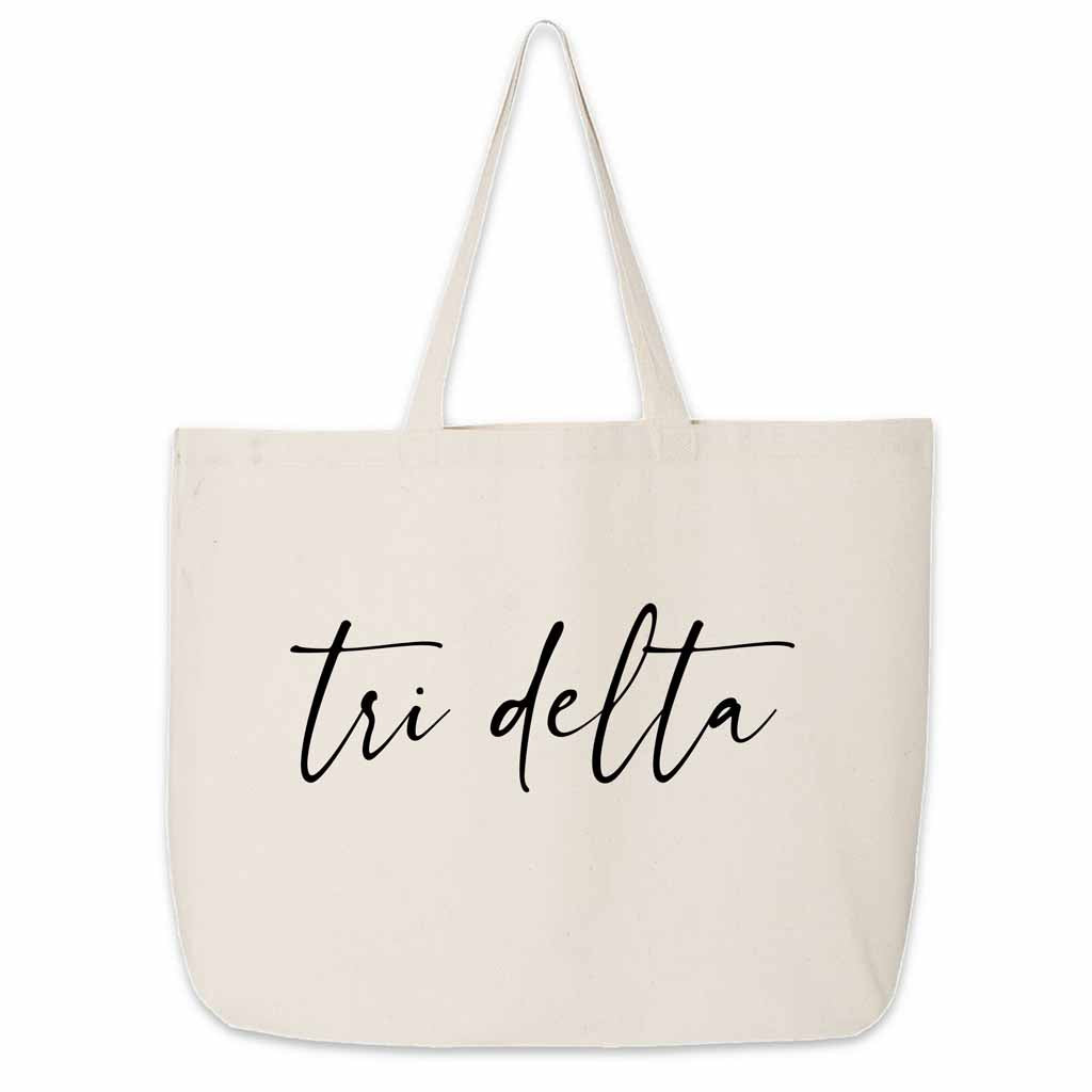 The perfect carry all for all your college sorority gear this Tri Delta sorority nickname printed on canvas tote bag in script writing.
