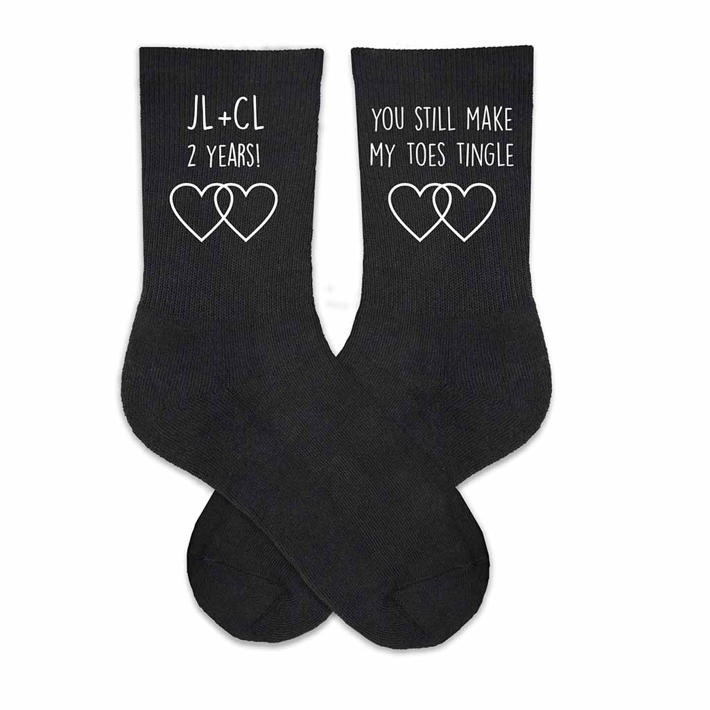You make my toes tingle custom printed on the sides of black cotton crew socks personalized with your initials and wedding date.