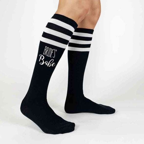 Comfortable bachelorette party black knee high socks with white stripes and Bride's Babe digitally printed in white ink 